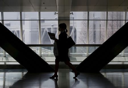 A female job seeker walks as she attends a job fair held for fresh graduates in Tokyo, Japan, March 20, 2016. Picture taken March 20, 2016. REUTERS/Yuya Shino