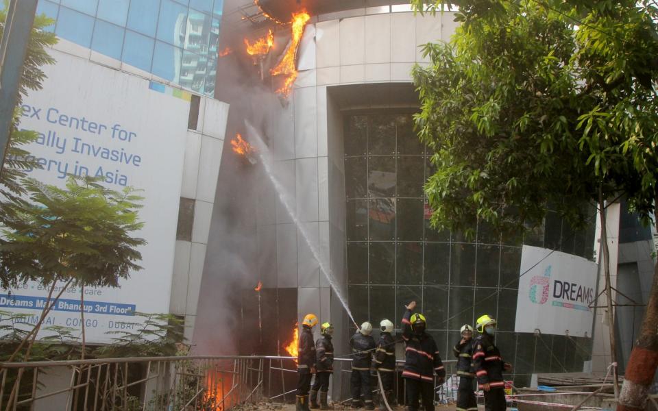 Firefighters try to douse the blaze at the Covid-19 facility in Mumbai - Stringer/Reuters