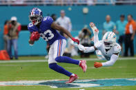 New York Giants wide receiver Pharoh Cooper (83) evades a tackle by Miami Dolphins cornerback Noah Igbinoghene (9) during the first half of an NFL football game, Sunday, Dec. 5, 2021, in Miami Gardens, Fla. (AP Photo/Lynne Sladky)