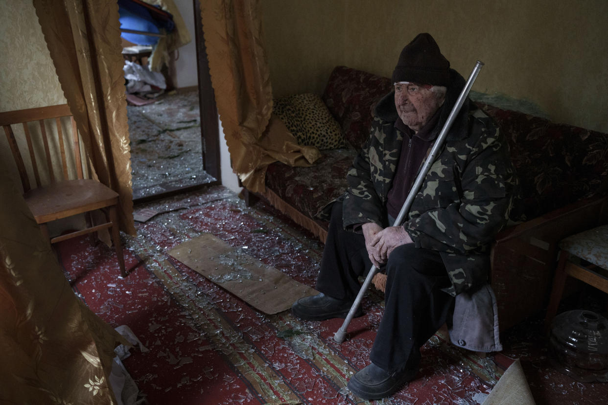 Ivan kobzarenko, 83, sits inside his damaged house with a head injury following a Russian drone attack in the village of Stari Bezradychi, Kyiv region, Ukraine, Monday, Dec. 19, 2022. (AP Photo/Felipe Dana)