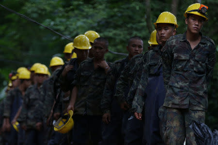 Military personnel leave the Tham Luang cave complex, where 12 boys and their soccer coach are trapped, in the northern province of Chiang Rai, Thailand, July 6, 2018. REUTERS/Athit Perawongmetha