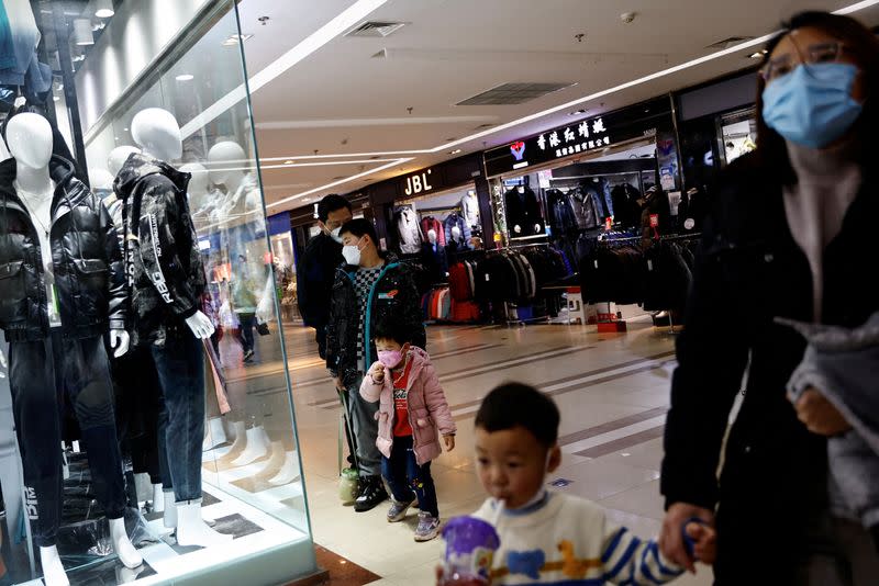 FILE PHOTO: Customers shop at a mall ahead of the Chinese Lunar New Year, in Beijing