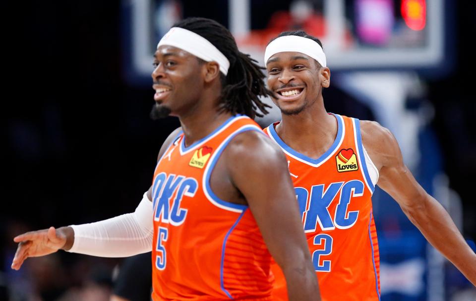 Thunder guards Shai Gilgeous-Alexander (2) celebrates with Luguentz Dort (5) against the Nets on March 14 at Paycom Center.