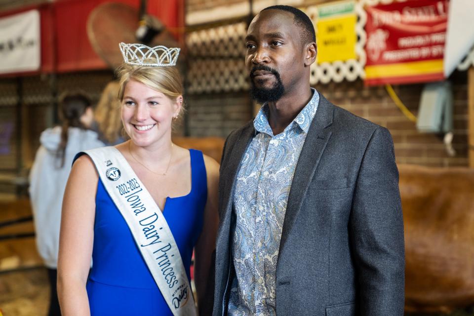 His Majesty William Wilberforce Kadhumbula Gabula Nadiope IV, King of Busoga, Uganda, poses for a photo with the Iowa Dairy Princess Naomi Scott, of West Gate, in the Cattle Barn at the Iowa State Fair on Monday.