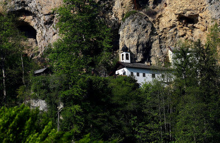 Hermit Stan Vanuytrecht of Belgium cuts trees outside his hermitage in Saalfelden, Austria, May 22, 2017. Picture taken May 22, 2017. REUTERS/Leonhard Foeger