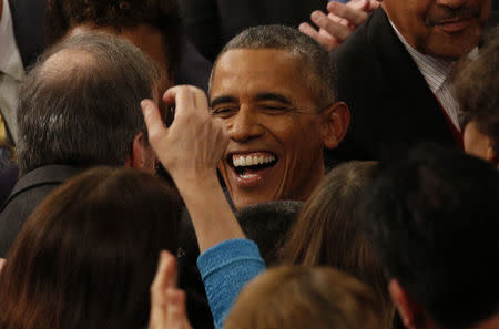 U.S. President Barack Obama smiles as he is greeted by members of Congress as he arrives to deliver his State of the Union address to a joint session of Congress in Washington, January 12, 2016. REUTERS/Kevin Lamarque