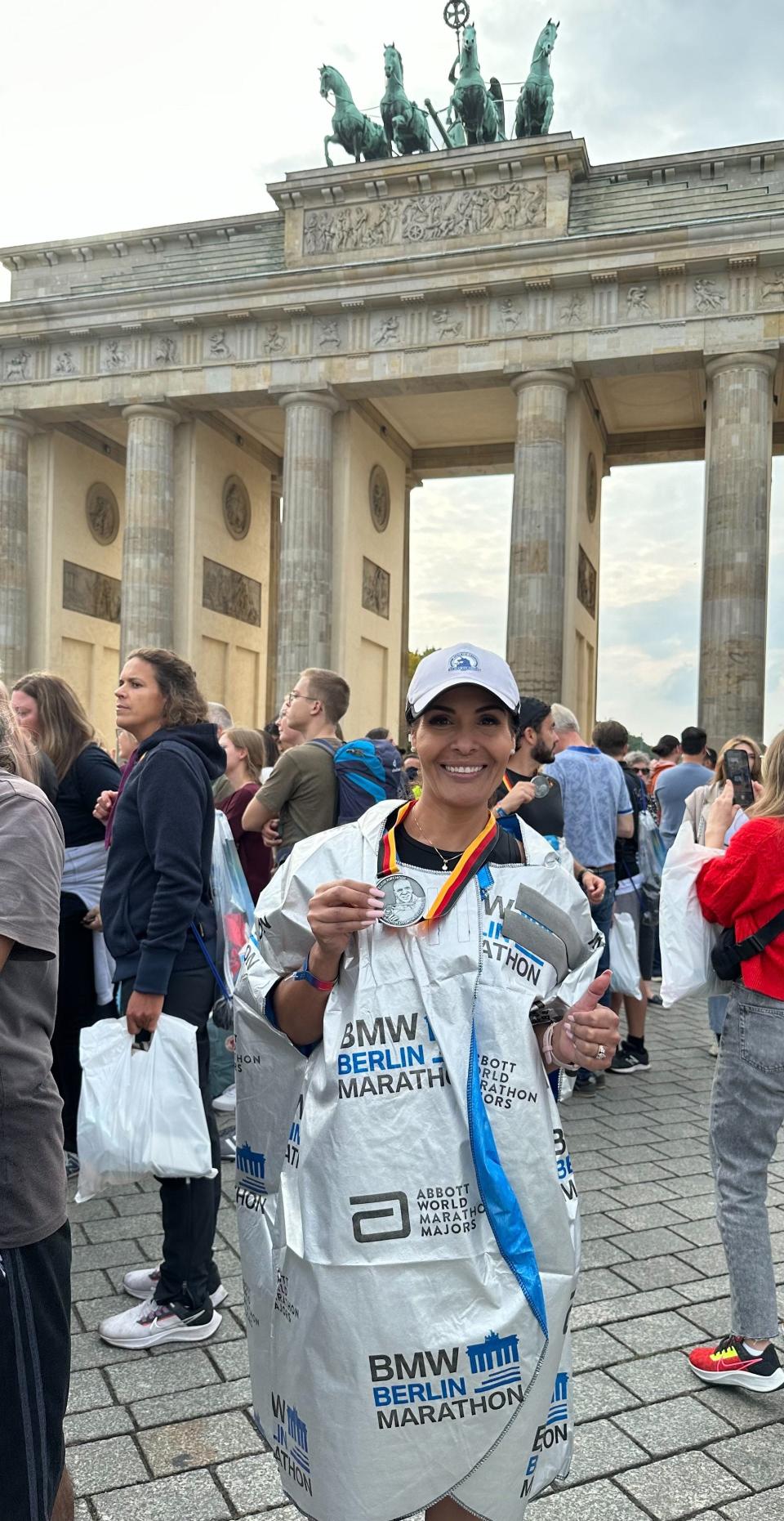 Malena Salazar poses with the medal she earned after completing the Berlin Marathon.