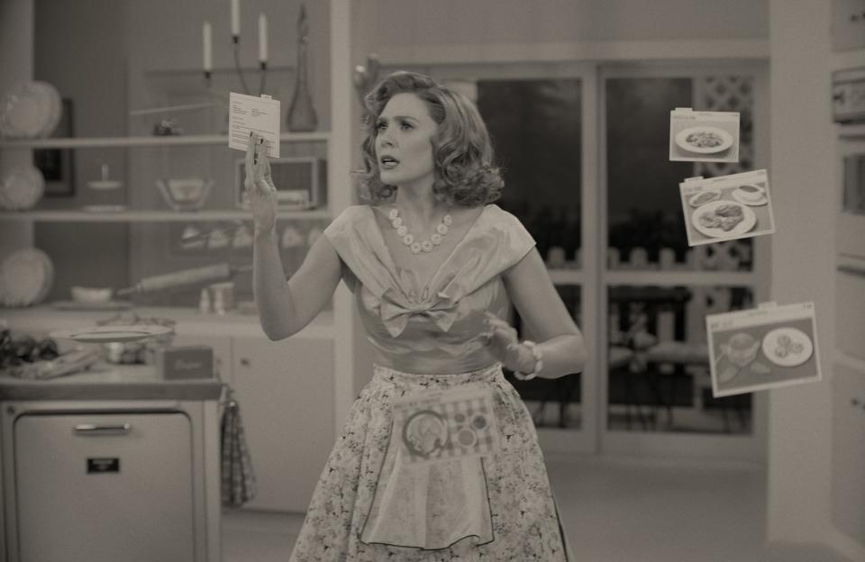 Wanda Maximoff (Elizabeth Olsen) conjures up dinner on the fly in the 1950s-set during the first episode of Disney+'s "WandaVision."