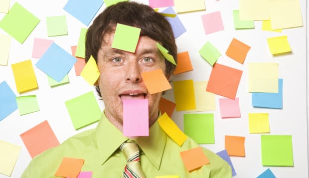 Businessman with adhesive note on forehead