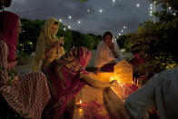 <p>People light candles and offer prayers at a grave of their relative in a local graveyard of Karachi, Pakistan on the occasion of Shab-e-Barat, June 13, 2014, 2014. (AP Photo/Shakil Adil) </p>