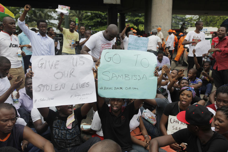 People attend a demonstration calling on government to rescue kidnapped school girls of a government secondary school Chibok, during workers day celebration in Lagos, Nigeria. Thursday, May, 1. 2014, Scores of girls and young women kidnapped from a school in Nigeria are being forced to marry their Islamic extremist abductors, a civic organization reported Wednesday. At the same time, the Boko Haram terrorist network is negotiating over the students' fate and is demanding an unspecified ransom for their release, a Borno state community leader told The Associated Press. He said the Wednesday night message from the abductors also claimed that two of the girls have died from snake bites. The message was sent to a member of a presidential committee mandated last year to mediate a ceasefire with the Islamic extremists, said the civic leader, who spoke on condition of anonymity because he is not authorized to speak about the talks. (AP Photo/ Sunday Alamba)