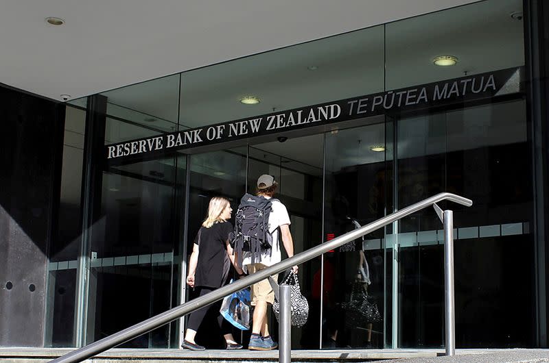 FILE PHOTO: FILE PHOTO: Two people walk towards the entrance of the Reserve Bank of New Zealand located in the New Zealand capital city of Wellington