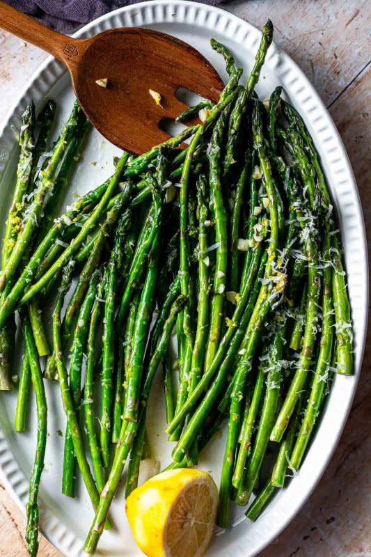 <p>Sweet Tea and Thyme</p><p>This garlic lemon asparagus recipe is a super easy side dish that your family will absolutely love! Fresh spring asparagus is sautéed with fresh lemon juice, zest, and garlic, then served with a sprinkle of delicious parmesan cheese. It's the best way to cook up that fresh spring produce.</p><p><strong>Get the recipe: <a href="https://www.sweetteaandthyme.com/lemon-garlic-sauteed-asparagus-2/" rel="nofollow noopener" target="_blank" data-ylk="slk:Easy Sautéed Lemon Garlic Asparagus;elm:context_link;itc:0;sec:content-canvas" class="link rapid-noclick-resp">Easy Sautéed Lemon Garlic Asparagus</a></strong></p>