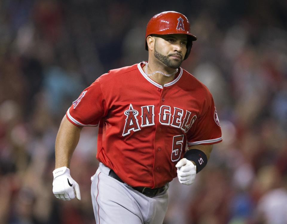 Los Angeles Angels Albert Pujols (5) begins to circle the bases after hitting his career 500th home run against Washington Nationals Taylor Jordan in the fifth inning of a baseball game in Washington, Tuesday, April 22, 2014. (AP Photo/Pablo Martinez Monsivais)