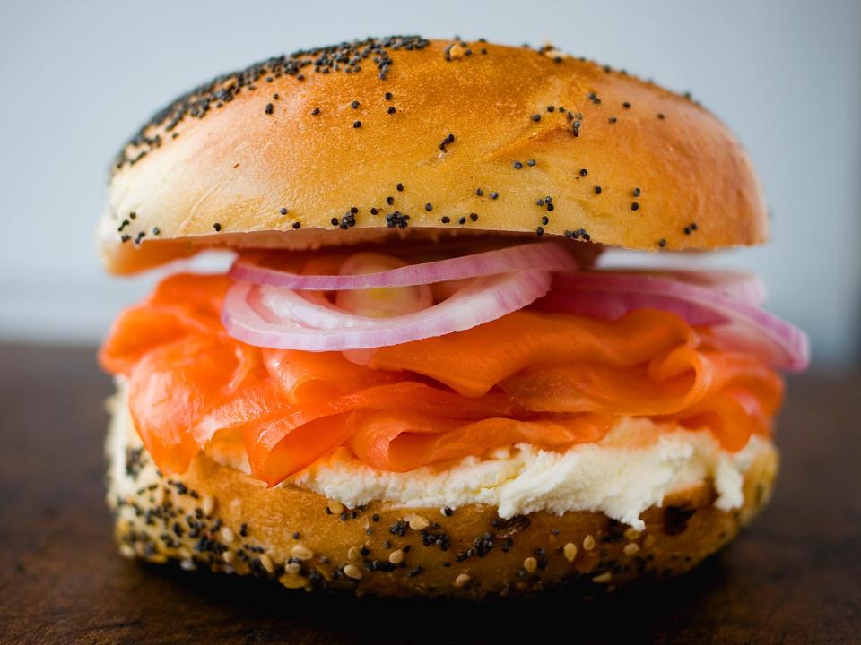 A poppy-seed bagel with lox and fixings.