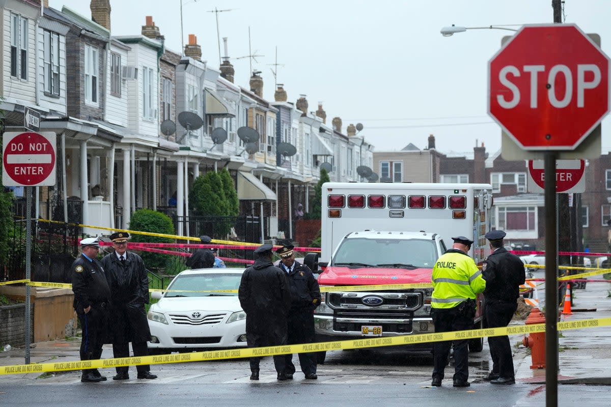 Law enforcement gather at the scene of a fatal shooting in Philadelphia, Friday (AP)