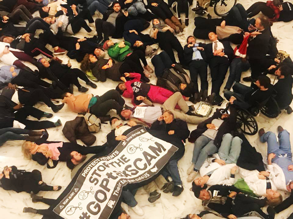 Ady Barkan and dozens of other protesters participate in a die-in against the GOP tax bill in the Russell Senate Office Building on Dec. 18, 2017. (Photo: Center for Popular Democracy)