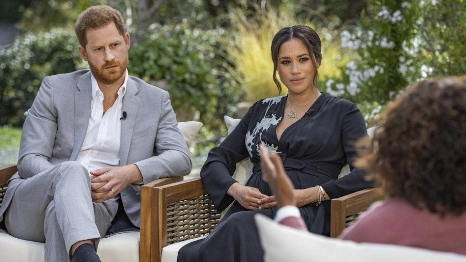 Prince Harry, left, and Meghan, the Duchess of Sussex, chat with interviewer Oprah Winfrey during a bombshell interview that aired March 7 on CBS.