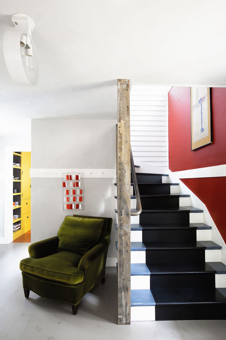 <p>In this Connecticut stairway by <a rel="nofollow noopener" href="https://deringhall.com/interior-designers/fawn-galli-interiors" target="_blank" data-ylk="slk:Fawn Galli Interiors;elm:context_link;itc:0;sec:content-canvas" class="link ">Fawn Galli Interiors</a>, risers are white and treads are blue with a wide black stripe painted down the center of both. </p>