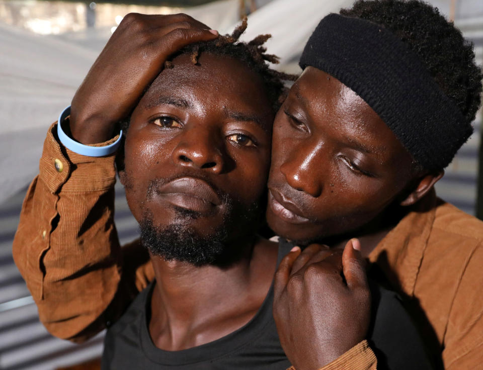 Ugandan refugees Kimuli Brian and Dennis Wasswa, members of the LGBT community, embrace each other inside their shelter at the Kakuma refugee camp, in Turkana county (Goran Tomasevic / Reuters)
