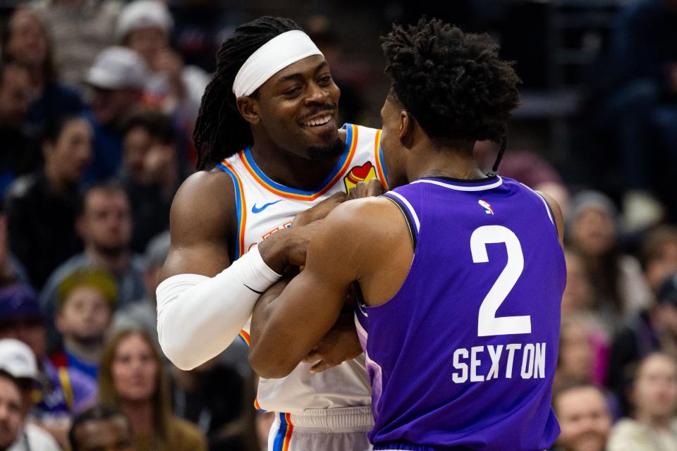 Oklahoma City Thunder guard <a class="link " href="https://sports.yahoo.com/nba/players/6254/" data-i13n="sec:content-canvas;subsec:anchor_text;elm:context_link" data-ylk="slk:Luguentz Dort;sec:content-canvas;subsec:anchor_text;elm:context_link;itc:0">Luguentz Dort</a> (5) smiles while he and Utah Jazz guard Collin Sexton (2) hold onto the ball during an NBA basketball game between the Utah Jazz and the Oklahoma City Thunder at the Delta Center in Salt Lake City on Tuesday, Feb. 6, 2024. | Megan Nielsen, Deseret News