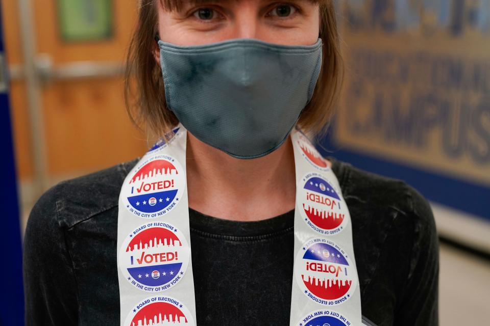 A poll worker wears stickers around her neck at a polling place in New York, Tuesday, Nov. 2, 2021. (AP Photo/Seth Wenig) ORG XMIT: NYSW119