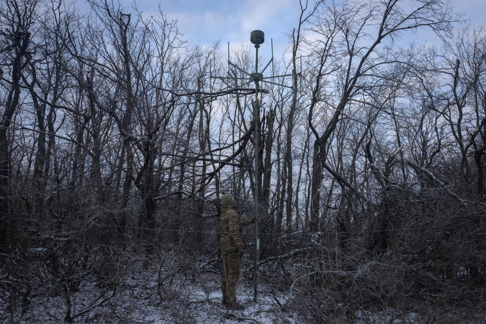 A Ukrainian soldier installs an electronic warfare system antenna to listen to Russian chatter at the front line near Bakhmut, Donetsk region, Ukraine, Monday, Jan. 29, 2024. Ukrainian forces are increasingly resorting to an age-old tactic — intelligence gleaned from radio intercepts — in a desperate effort to preserve their most vital resources. The painstaking work of eavesdropping is part of a larger effort to beef up and refine electronic warfare capabilities so that soldiers can be warned earlier of impending attacks, while having the battlefield intelligence needed to make their own strikes more deadly. (AP Photo/Efrem Lukatsky)
