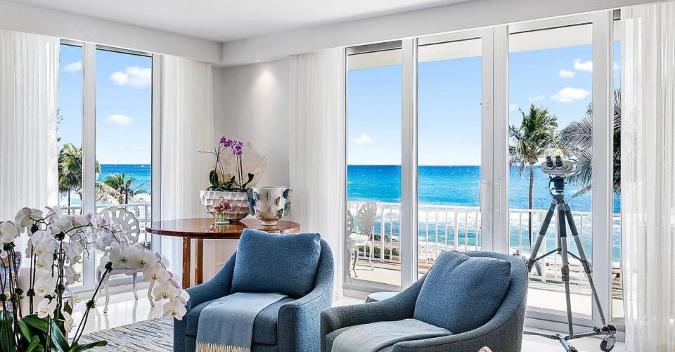 Floor-to-ceiling windows and glass doors in the living room of Unit 3A offer views of the Atlantic Ocean from a condo in the Kirkland House, 101 Worth Ave. in Midtown Palm Beach. The condo just changed hands for a recorded $11.93 million.