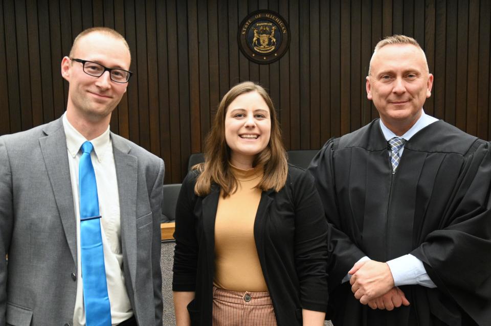 Prosecutor Zack Stempien, newly sworn in attorney Emily Mowry, and Circuit Judge Bill O'Grady who swore Mowry into the Michigan Bar Monday.