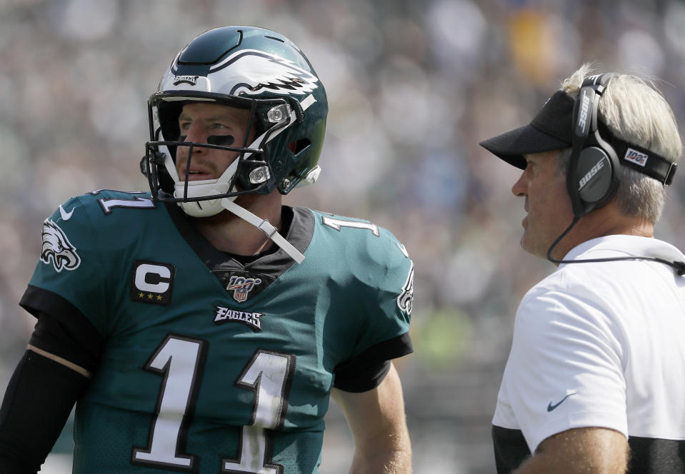 FILE - Philadelphia Eagles' Carson Wentz talks to head coach Doug Pederson during an NFL football game against the Detroit Lions, Sunday, Sept. 22, 2019, in Philadelphia. Carson Wentz makes his debut as Washington Commanders quarterback and Doug Pederson makes his debut as Jacksonville Jaguars coach less than two years removed from the end of their time together in Philadelphia. (AP Photo/Michael Perez, File)