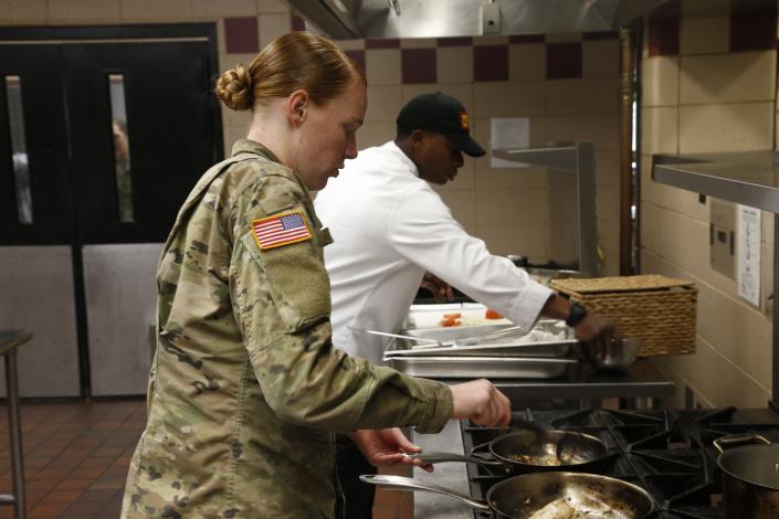 Private first class Michelle Owenby, near, and sergeant Jamal Spruill compete in a culinary competition at Week of the Eagles at Fort Campbell on May 23.