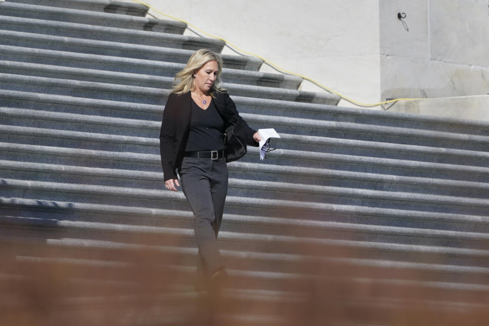 Rep. Marjorie Taylor Greene, R-Ga., walks down the steps as she heads to a news conference on Capitol Hill in Washington, Friday, Feb. 5, 2021. (AP Photo/Susan Walsh)