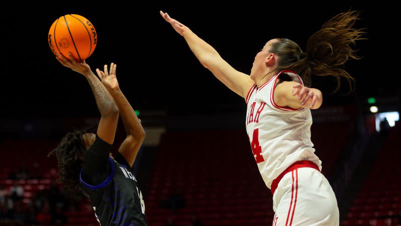 Weber State guard Kaiija Lesane shoots against Utah guard Kennady McQueen during game against Weber State at the Jon M. Huntsman Center in Salt Lake City on Thursday, Dec. 21, 2023.