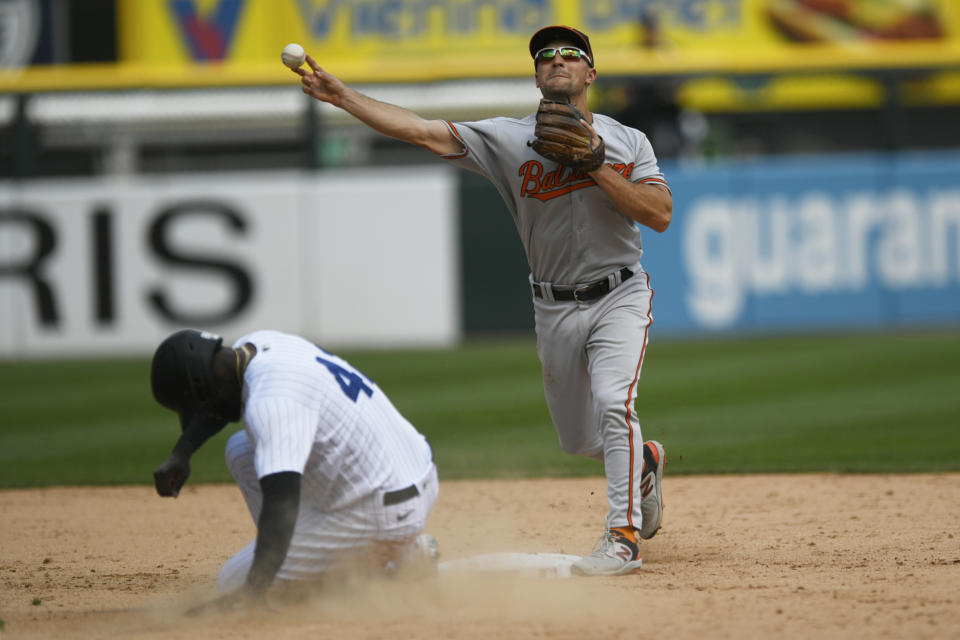 Baltimore Orioles second baseman Adam Frazier throws to first base after forcing out Chicago White Sox's Luis Robert Jr. at second base during the fifth inning of a baseball game Saturday, April 15, 2023, in Chicago. Chicago won 7-6 in 10 innings. (AP Photo/Paul Beaty)
