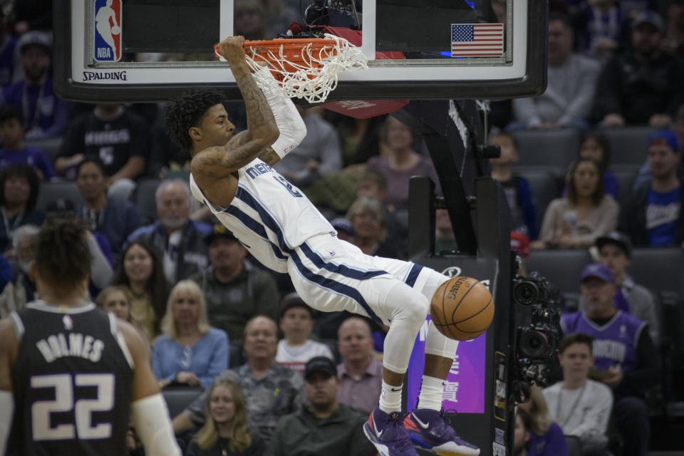 Memphis Grizzlies guard Ja Morant (12) dunks against the Sacramento Kings during the first quarter of an NBA basketball game in Sacramento, Calif., Thursday, Jan. 2, 2020. (AP Photo/Randall Benton)