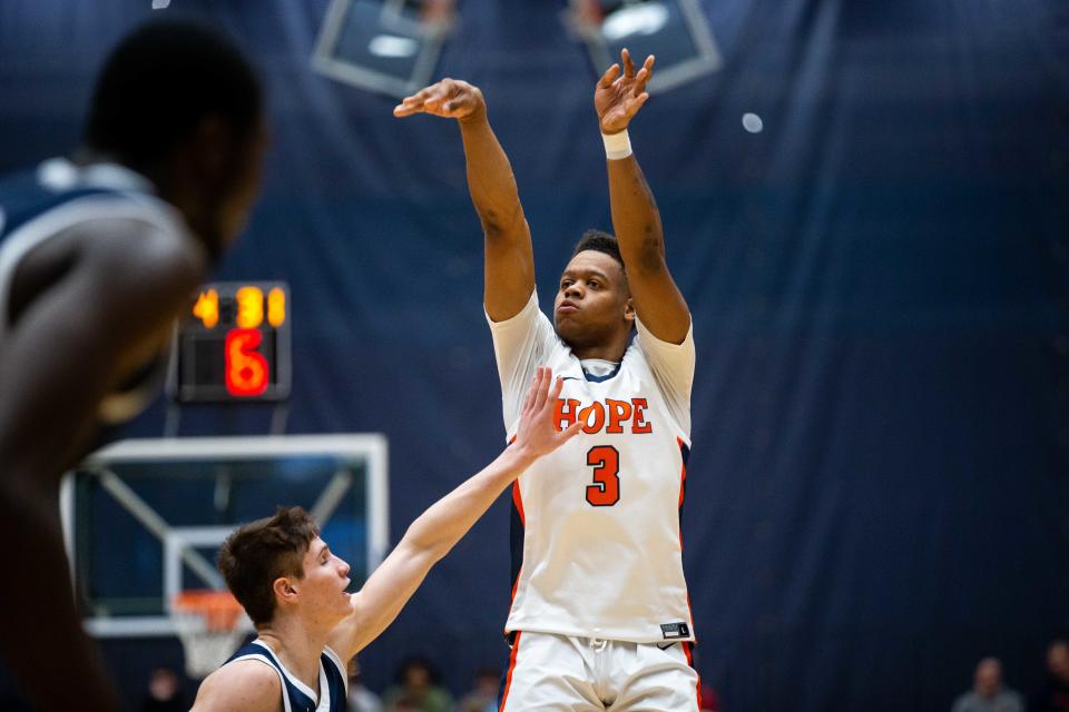 Hope's TJ McKenzie launches a shot from beyond the arc at DeVos Fieldhouse.