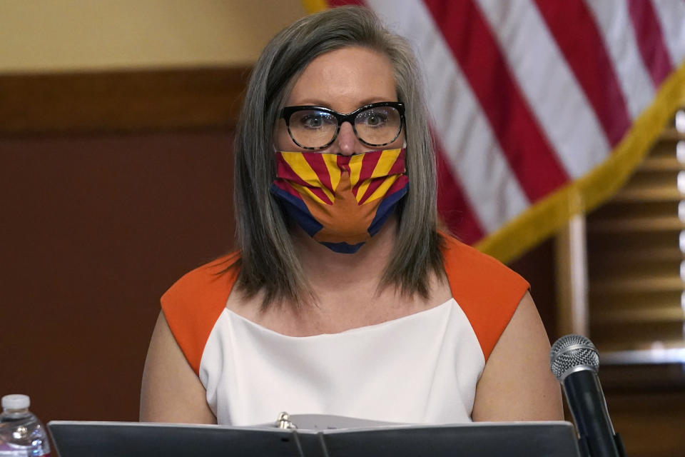 Arizona Secretary of State Katie Hobbs reads a statement prior to certifying the election results for federal, statewide, and legislative offices and statewide ballot measures at the official canvass at the Arizona Capitol Monday, Nov. 30, 2020, in Phoenix. (AP Photo/Ross D. Franklin, Pool)