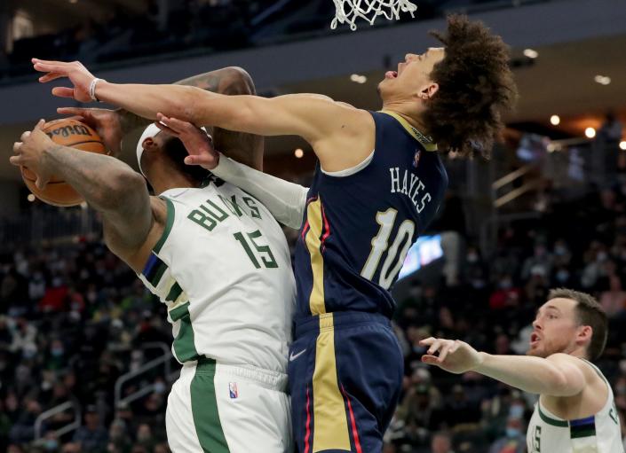 New Orleans Pelicans guard Jaxaon Hayes (10) fouls Milwaukee Bucks center DeMarcus Cousins (15) during the first half of their game Saturday, January 1, 2022 at Fiserv Forum in Milwaukee, Wis.MARK HOFFMAN/MILWAUKEE JOURNAL SENTINEL