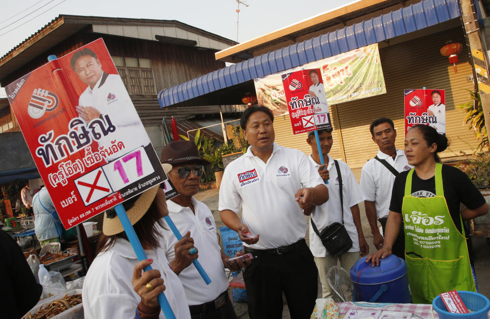 In this March 14, 2019, photo, Veerawit Chuajunud, center, who changed his name to Thaksin Chuajunud of Pheu Chart party, makes his election campaign in Nakhon Ratchasima, Thailand. Thailand’s former Prime Minister Thaksin Shinawatra is in exile and banned from interfering in the country’s politics. But his name is a powerful political attraction and in tribute, and to win votes, some candidates in general election on Sunday, March 24, 2019 have changed their names to Thaksin so supporters of the former leader can register their loyalty at the ballot box. (AP Photo/Sakchai Lalit)