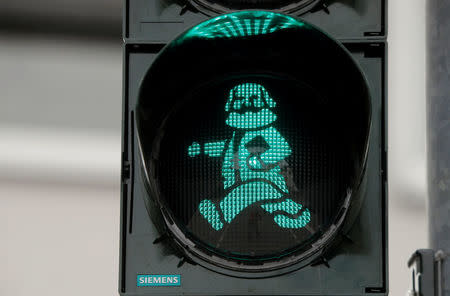 FILE PHOTO: An image of German philosopher Karl Marx is seen in a traffic light for passengers in his hometown in Trier, Germany, April 13, 2018. REUTERS/Wolfgang Rattay/File Photo