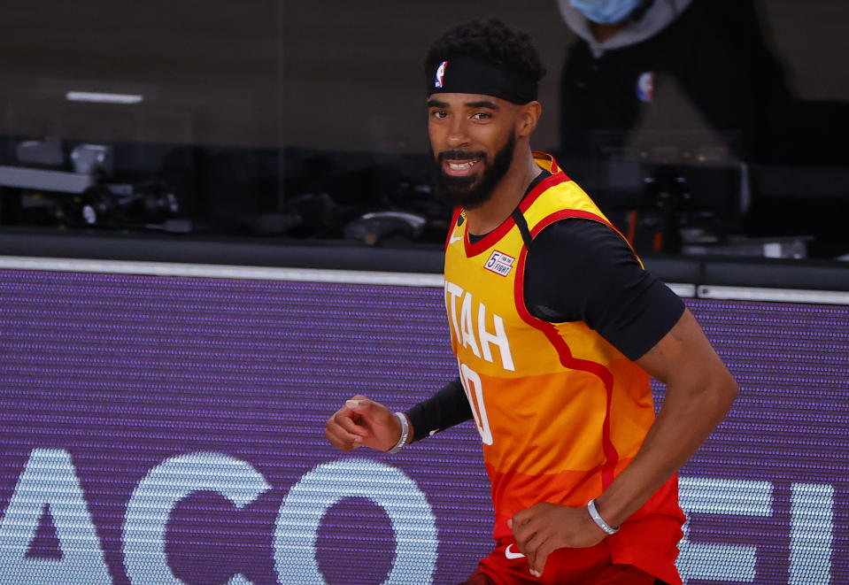 Mike Conley in a citrus-like Utah Jazz uniform. 