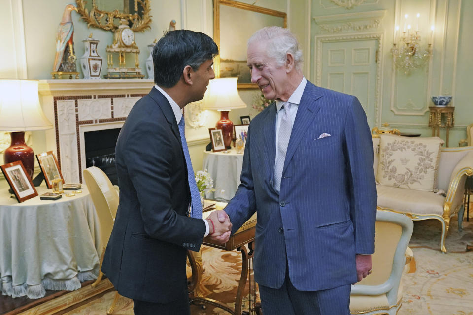 King Charles III, right, and Britain's Prime Minister Rishi Sunak shake hands during their meeting at Buckingham Palace, London, Wednesday, Feb. 21, 2024. (Jonathan Brady/Pool Photo via AP)