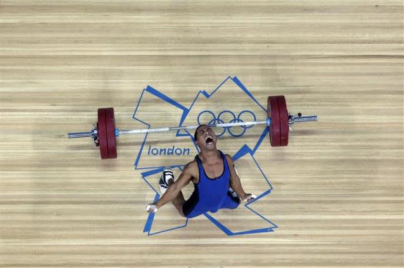 Micronesia's Manuel Minginfel drops weights on the men's 62Kg Group B weightlifting competition at the London 2012 Olympic Games July 30, 2012.