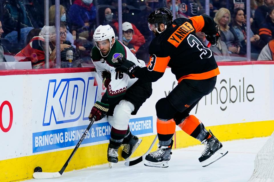 Arizona Coyotes' Andrew Ladd, left, and Philadelphia Flyers' Keith Yandle battle for the puck during the first period of an NHL hockey game, Tuesday, Nov. 2, 2021, in Philadelphia. (AP Photo/Matt Slocum)