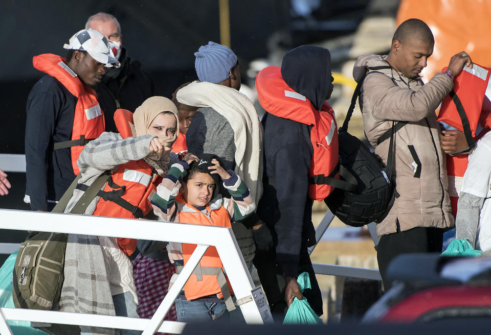 Migrants disembark at Hay Wharf, Pieta, Malta, Wednesday, Jan. 9, 2019. The 49 rescued migrants who were stranded at sea since last month were brought to Malta and then distributed among eight European Union countries. The deal, announced by Maltese Prime Minister Joseph Muscat, breaks a stalemate that began after 32 were rescued by a German aid group's vessel on Dec. 22. The other 17 were rescued on Dec. 29 by a different aid boat. Both Italy and Malta have refused to let private rescue ships bring migrants to their shores. (AP Photo/Rene Rossignaud)