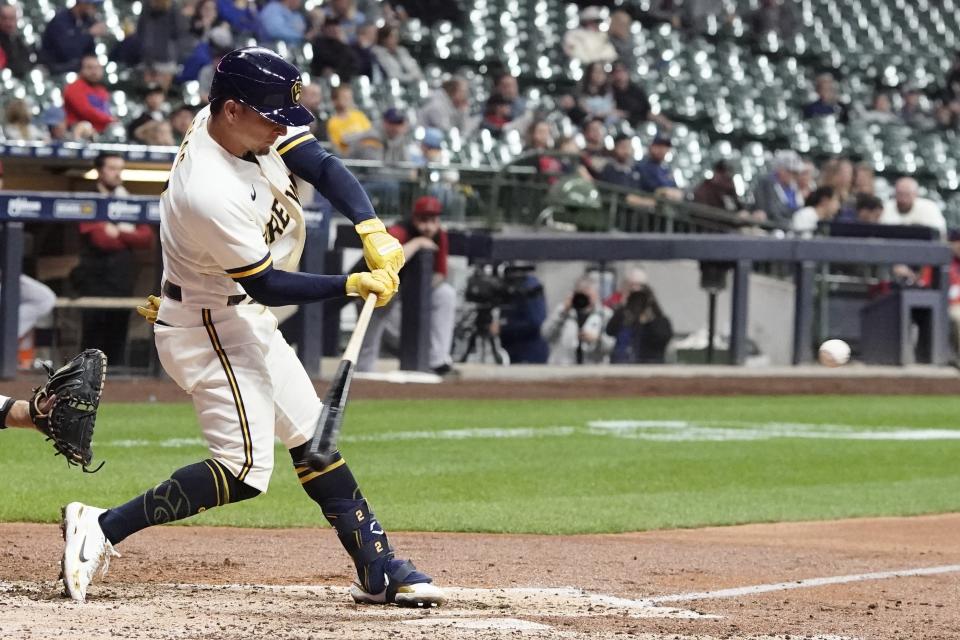 Milwaukee Brewers' Luis Urias hits a double during the fifth inning of a baseball game against the Arizona Diamondbacks Monday, Oct. 3, 2022, in Milwaukee. (AP Photo/Morry Gash)