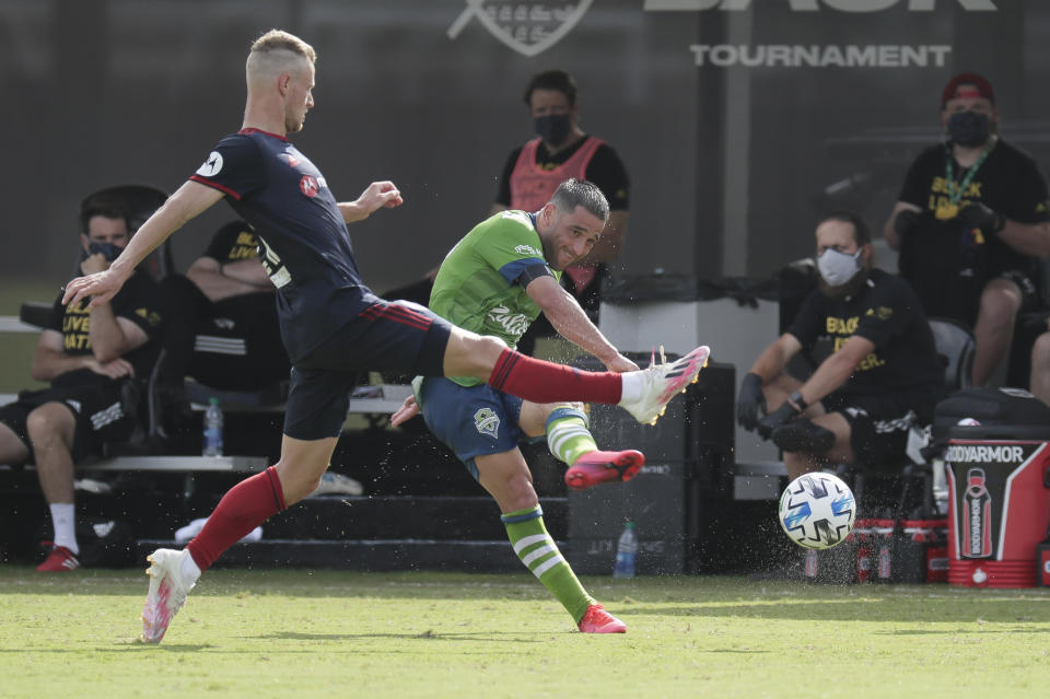 Seattle Sounders midfielder Nicolas Lodeiro, right, takes a shot on goal as Chicago Fire midfielder Fabian Herbers, left, tries to block the shot during the first half of an MLS soccer match, Tuesday, July 14, 2020, in Kissimmee, Fla. (AP Photo/John Raoux)