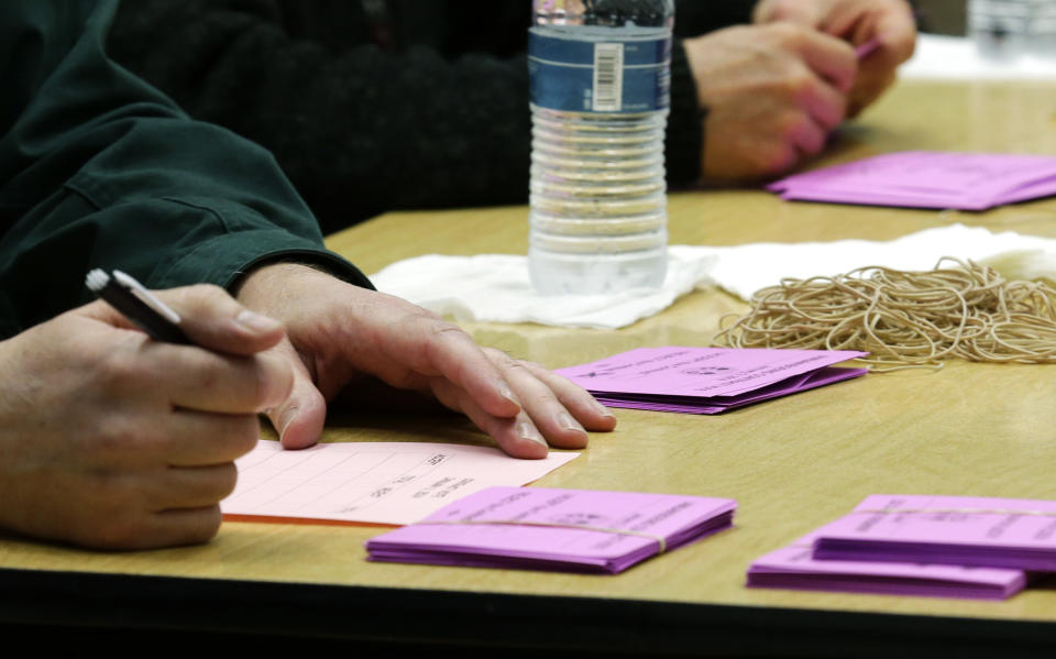 A volunteer vote counter tallies ballots Friday, Jan. 3, 2014, at the Boeing Machinists union hall in Seattle. Workers were voting on the Boeing Co.'s latest contract offer to keep the assembly of the Being 777X airplane in Washington state. (AP Photo/Ted S. Warren)