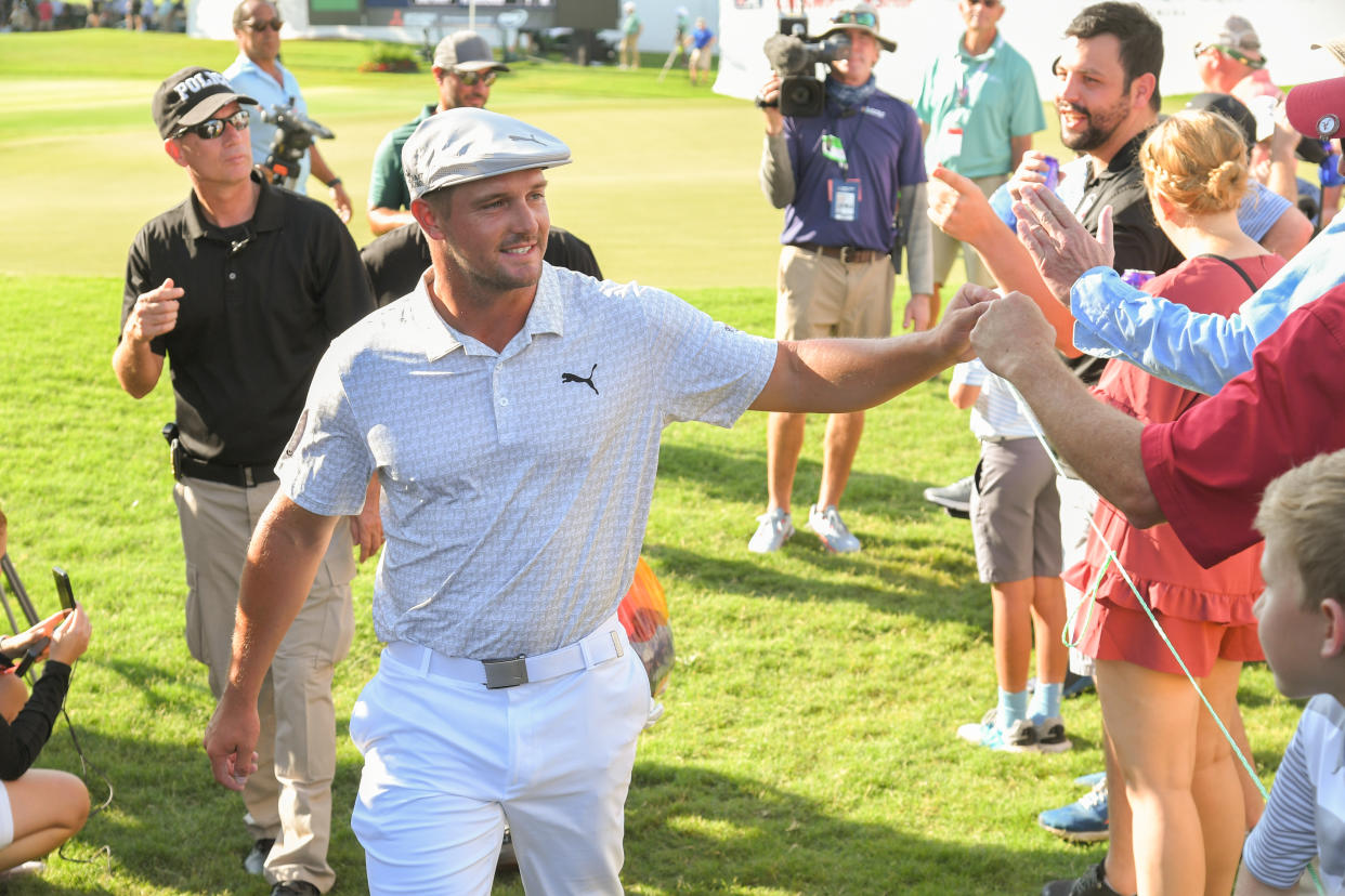 ATLANTA, GA - SEPTEMBER 02: Bryson DeChambeau fist bumps fans while walking off the 18th hole during the first round of the TOUR Championship at Eastlake Golf Club on September 2, 2021 in Atlanta, Georgia. (Photo by Ben Jared/PGA TOUR via Getty Images)