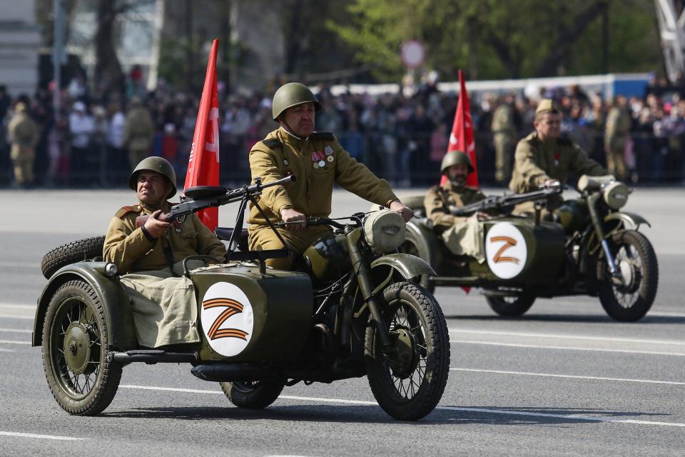 Men, pictured here wearing riding in WWII-era motorcycles adorned with stickers of the letter Z in Russia.